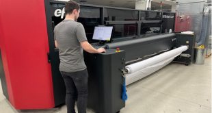 A member of the Venture Banners team with the EFI™ VUTEk® FabriVU® 340i Venture Banners marks 15th anniversary