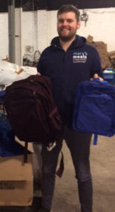 An employee of Mary’s Meals with some of the donated bags