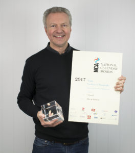 Allan + Bertram’s brand director, Stuart Bennett, with the award for Excellence in Photography