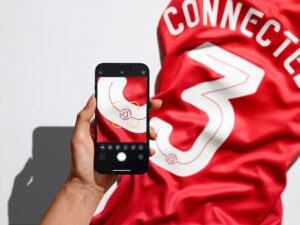 digital triggers shot 3a hand red shirt QR Reader Next gen personalised merch takes sports fandom local and global